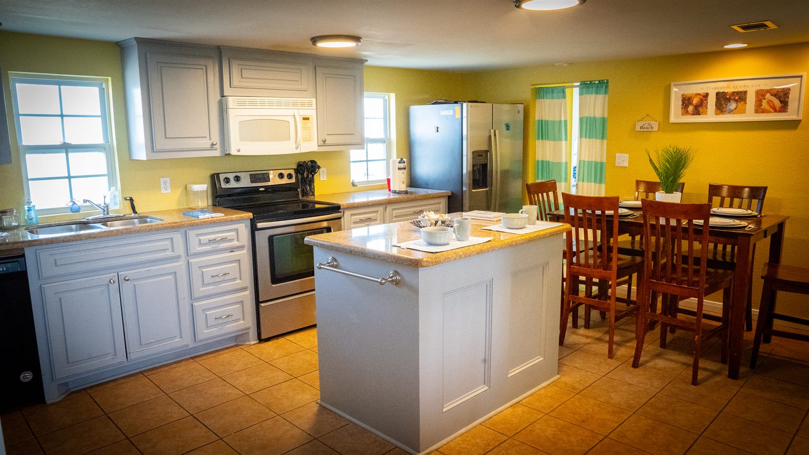 kitchen and dining area inside the beach house rental at The Palms RV Resort